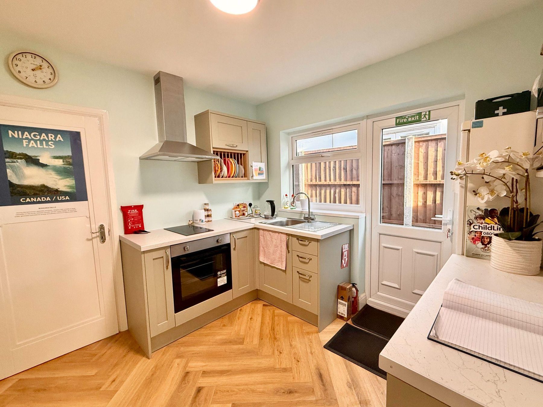 Kitchen with oven, hob, first aid kit and fire exit door