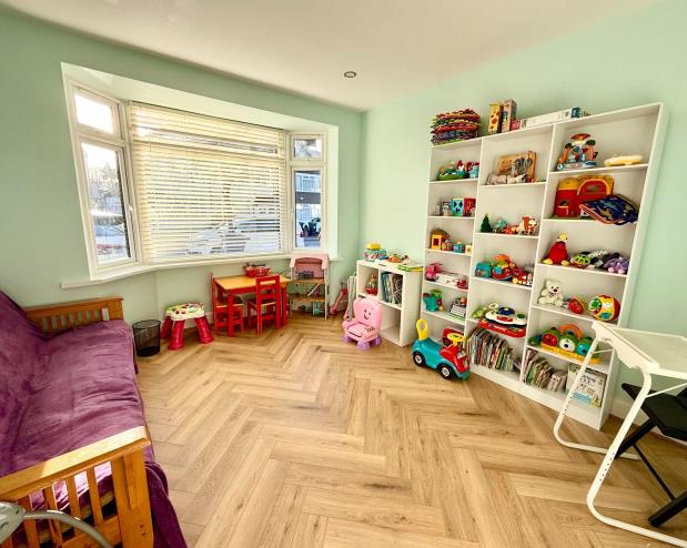 A bright family room with toys and comfortable seating
